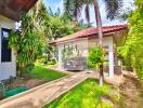 Outdoor view of a property with garden and carport