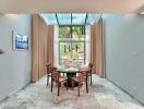 Bright dining room with glass roof and wooden furniture