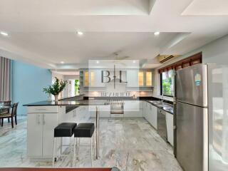 Spacious modern kitchen with granite countertops and stainless steel appliances