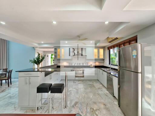 Spacious modern kitchen with granite countertops and stainless steel appliances