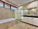 Modern bathroom with bathtub and glass-enclosed shower