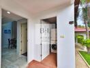 Entrance to laundry area with a view of the kitchen and outdoor space