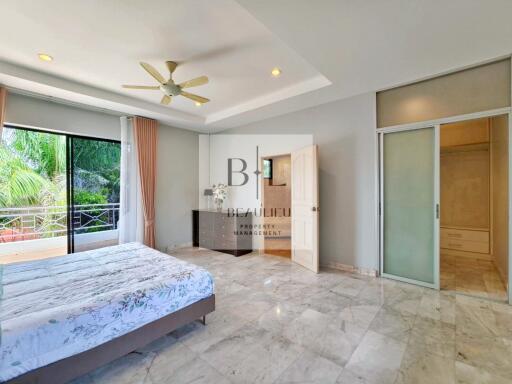 Spacious bedroom with balcony and natural light