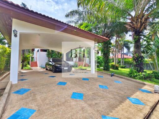 Covered parking area with a view of the garden