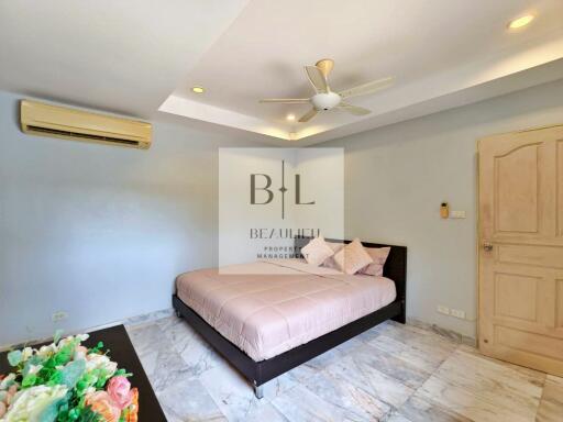 Spacious bedroom with ceiling fan and air conditioning