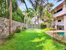 Spacious backyard with pool and lush greenery