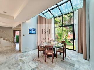 Spacious dining room with glass ceiling and garden view