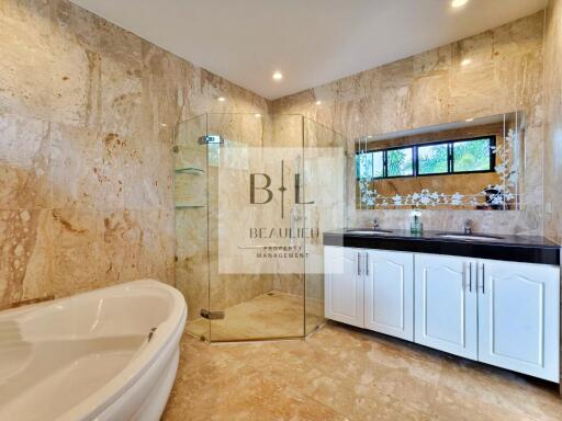 Spacious bathroom with glass shower and bathtub