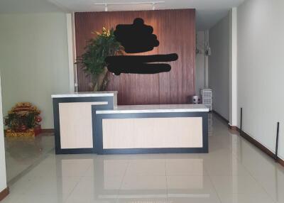 reception area with desk and plant