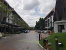 View of residential buildings with parking spaces and greenery