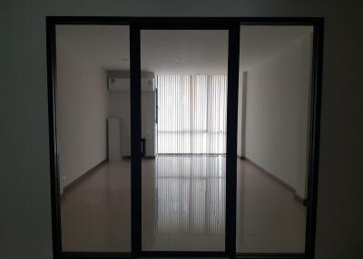 Modern living room with large glass door and window blinds