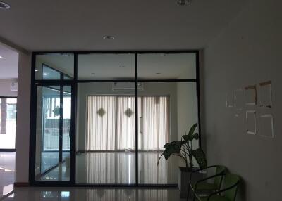 main lobby with glass partition and potted plants