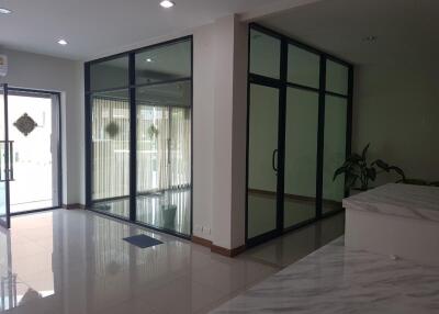 Spacious living area with glass doors and tiled flooring