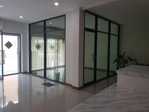 Spacious living area with glass doors and tiled flooring