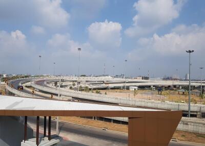 A view of a highway junction with multiple overpasses and a partially visible building