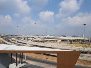 A view of a highway junction with multiple overpasses and a partially visible building