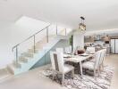 Bright dining area with modern kitchen and staircase