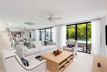 Spacious modern living room with natural light and pool view