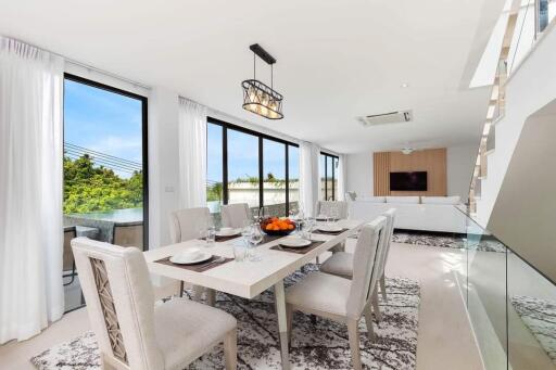 Modern dining and living area with large windows and a view