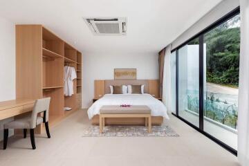 Modern bedroom with large windows and wooden furniture