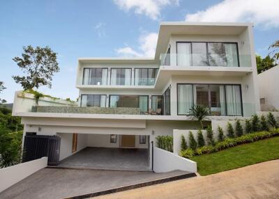 Modern two-story house with large windows and balcony