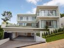 Modern two-story house with large windows and balcony