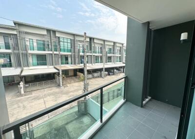 View of a balcony overlooking modern multi-story buildings