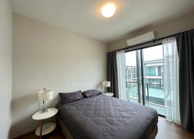 Bedroom with a large bed and a window offering a view