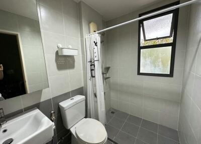 Modern bathroom with shower, toilet, and sink