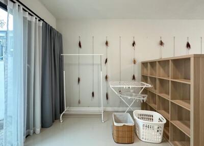 Laundry room with storage and drying racks