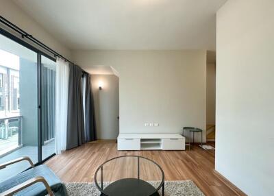 Minimalist living room with hardwood floor and large window