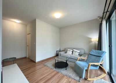 Modern living room with wooden flooring and large windows