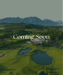 Coming Soon - Scenic view of a golf course with mountains in the background