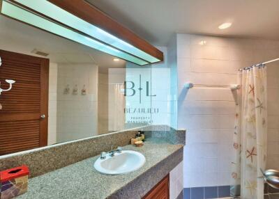 Modern bathroom with large mirror and granite countertop