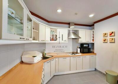 Modern kitchen with white cabinets and stainless steel appliances