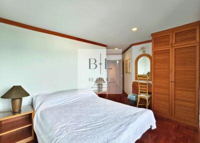 Bedroom with bed, wooden furniture, and decorative elements