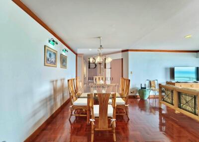 Dining area with a wooden table and chairs in a spacious living space