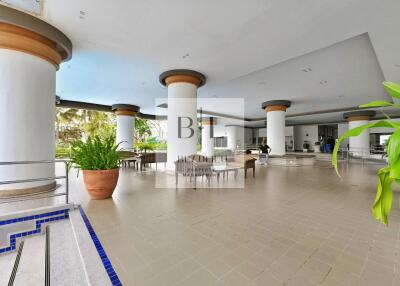 Spacious covered outdoor area with columns and seating