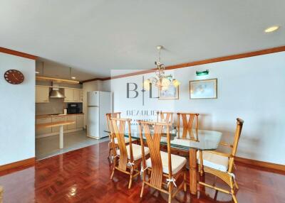 Dining area with wooden furniture and view of kitchen