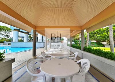 Covered outdoor seating area near swimming pool