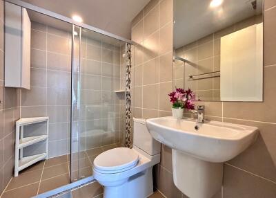 Modern bathroom with shower, toilet, and sink