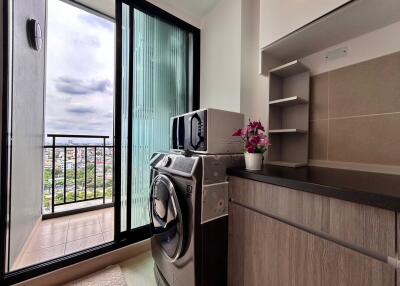 Modern laundry room with city view and balcony