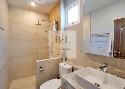 Modern bathroom with shower and large mirror