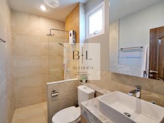 Modern bathroom with shower and large mirror