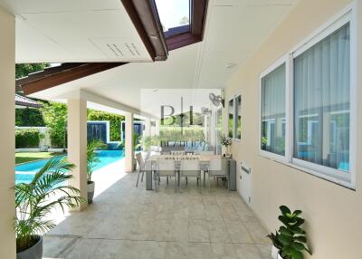 Spacious patio with dining area by the pool