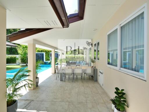 Spacious patio with dining area by the pool