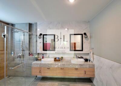 Modern bathroom with dual sinks and glass shower