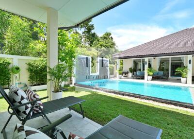 Outdoor area with pool and lounge chairs