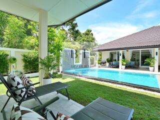 Outdoor area with pool and lounge chairs