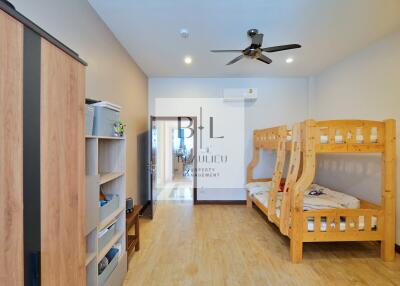 Bedroom with bunk beds, wardrobe, ceiling fan, and wooden floor